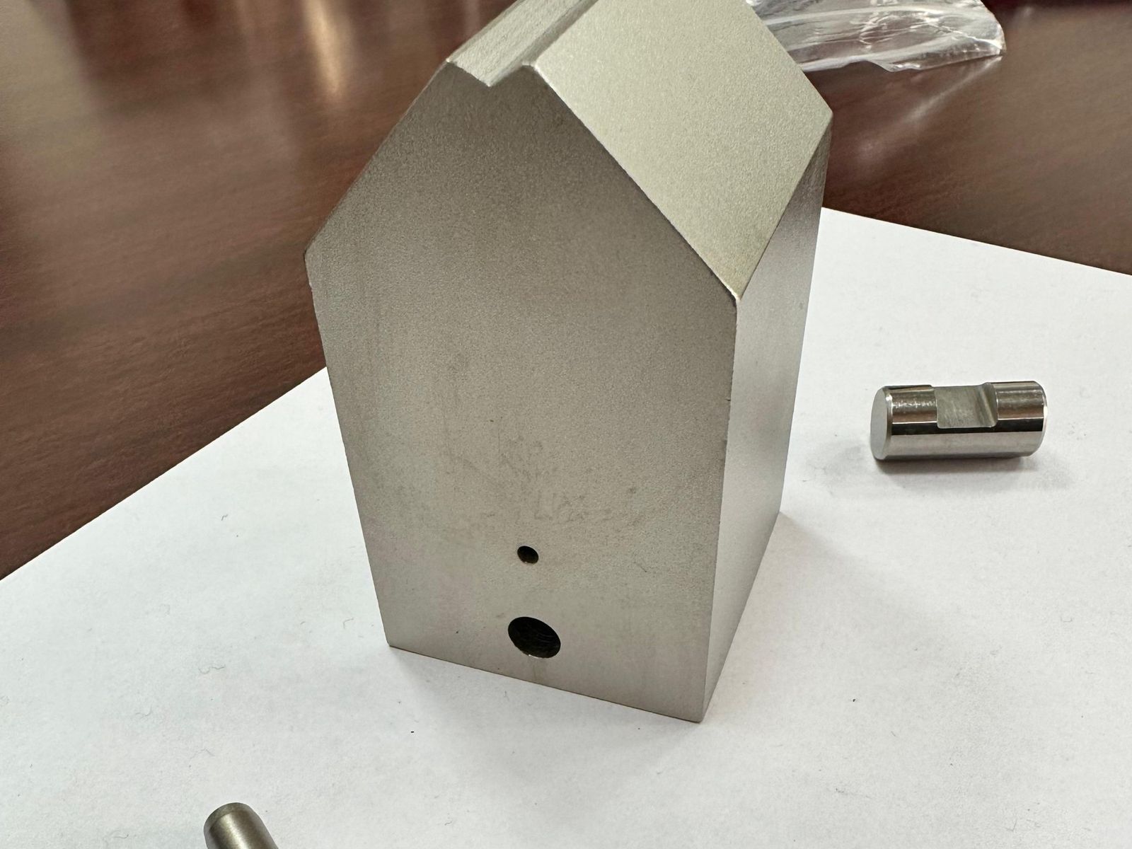 Machined block and pin plated with electroless nickel